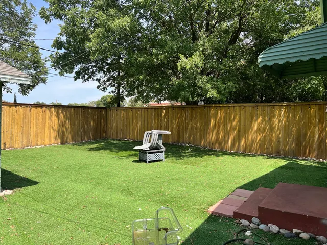 a view of a chair and table in the garden
