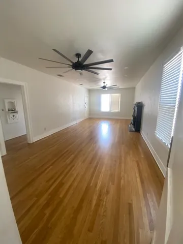 a view of a room with wooden floor and staircase