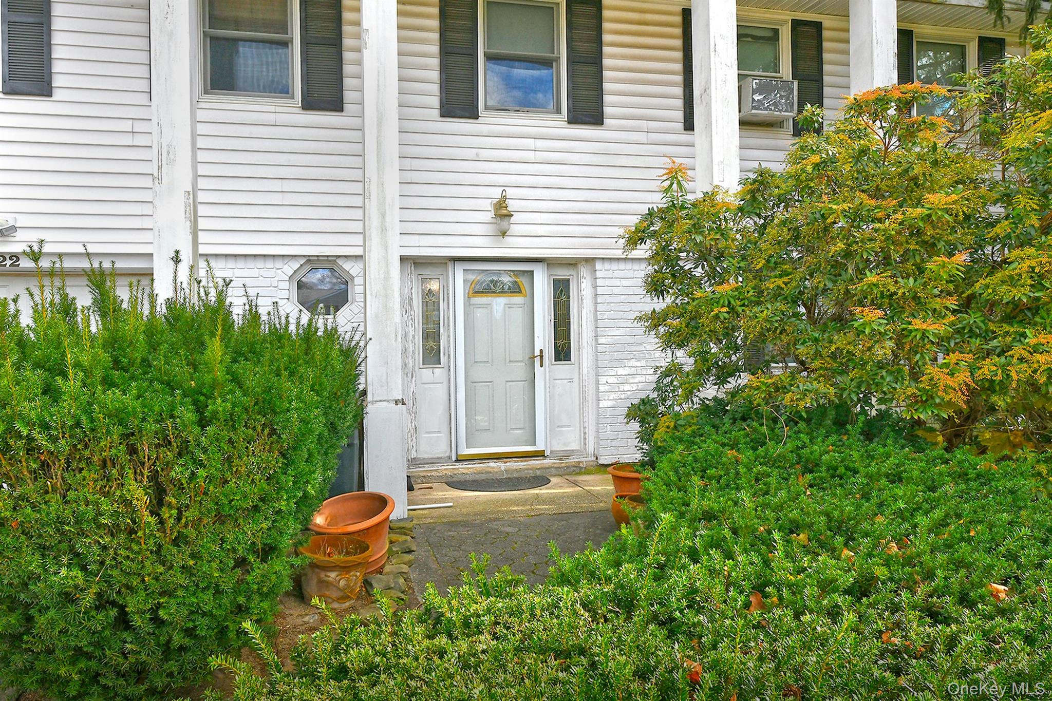 22 Suttonwood Drive Commack, NY 11725 - Photo 3 of 6 a backyard of a house with outdoor seating and plants