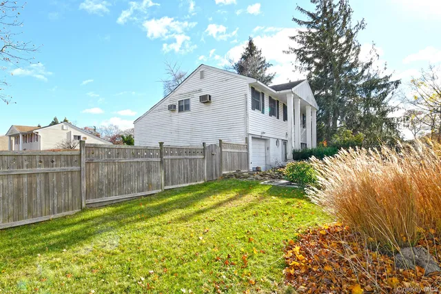 a view of a backyard with a white fence