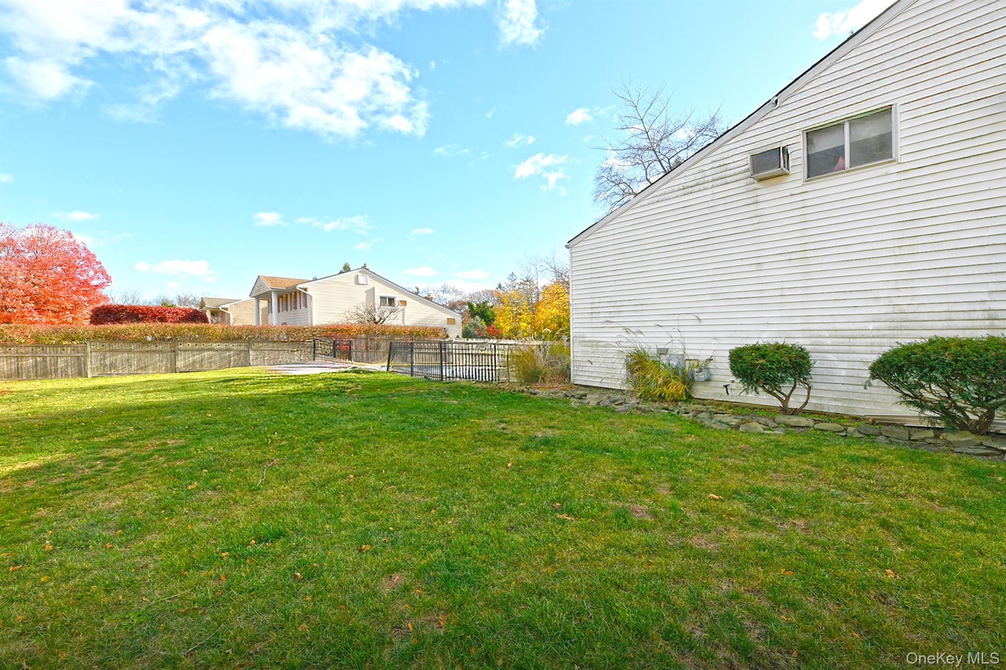 22 Suttonwood Drive Commack, NY 11725 - Photo 5 of 6 a view of a backyard with plants and a garden
