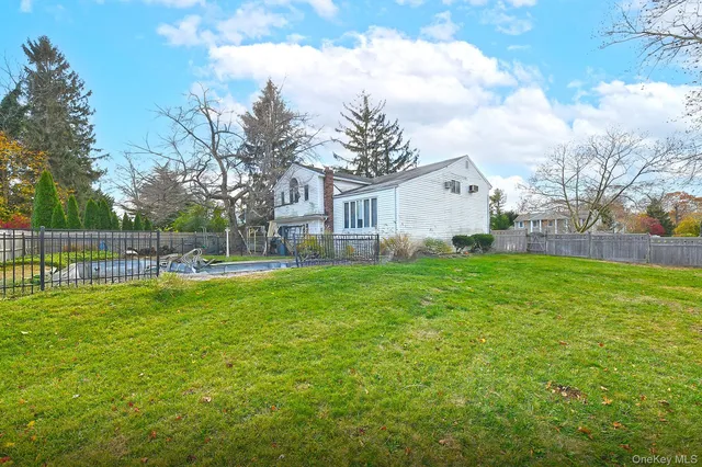 a view of a house with a yard and sitting area