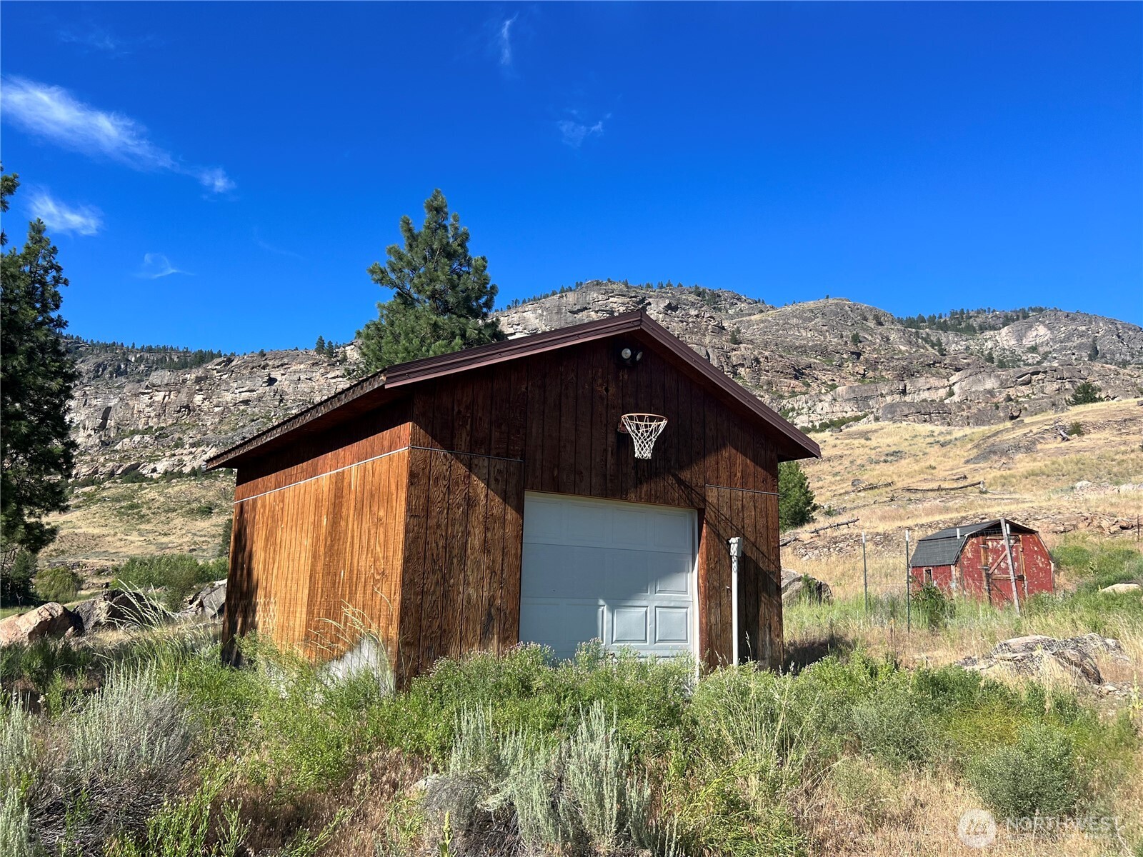 105 Swanson Mill Road Oroville, WA 98844 - Photo 23 of 37 a view of a house with a yard