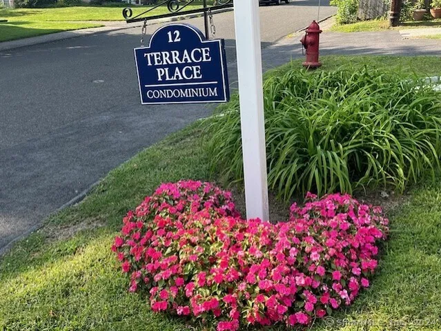 a sign that is in front of flowers