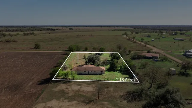 an aerial view of a residential houses with outdoor space
