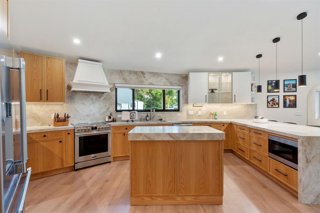 700 Old Nob Hill Road Plantation, FL 33324 - Photo 11 of 57 a kitchen with stainless steel appliances granite countertop a stove and a sink