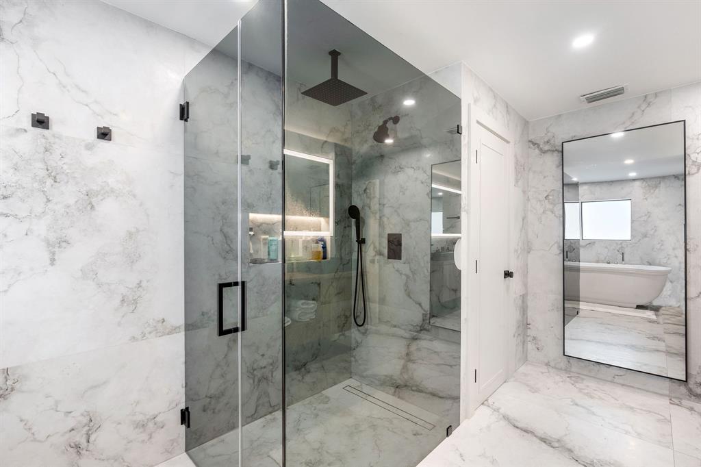 700 Old Nob Hill Road Plantation, FL 33324 - Photo 23 of 57 a bathroom with a glass shower door and a mirror