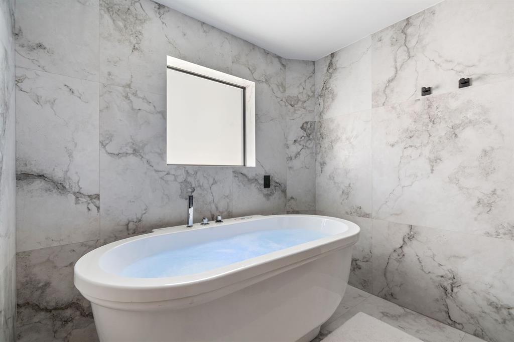 700 Old Nob Hill Road Plantation, FL 33324 - Photo 25 of 57 a white bath tub sitting in a bathroom