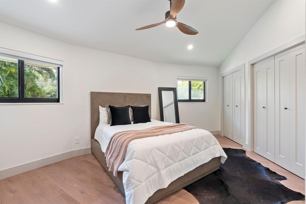 700 Old Nob Hill Road Plantation, FL 33324 - Photo 28 of 57 a bedroom with a large bed and a chandelier