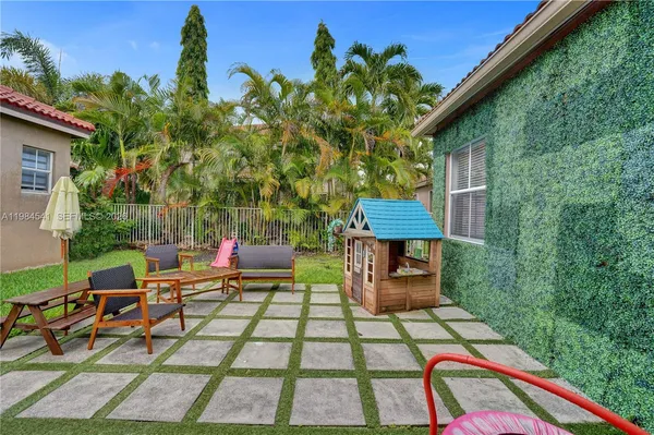 a view of a backyard with sitting area