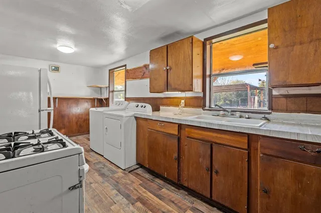a kitchen with a sink stove and refrigerator