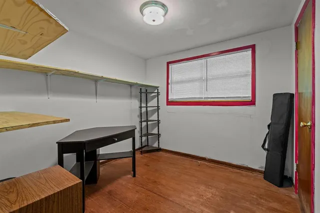 a view of room with window and wooden floor