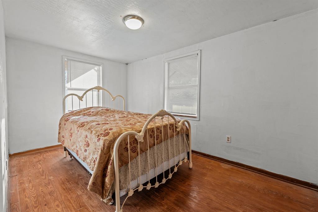 205 College Street Chico, TX 76431 - Photo 19 of 40 Bedroom with wood finished floors and a textured ceiling