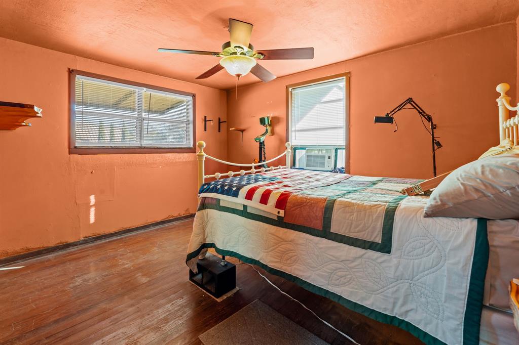 205 College Street Chico, TX 76431 - Photo 20 of 40 Bedroom with wood finished floors, a ceiling fan, and a textured ceiling