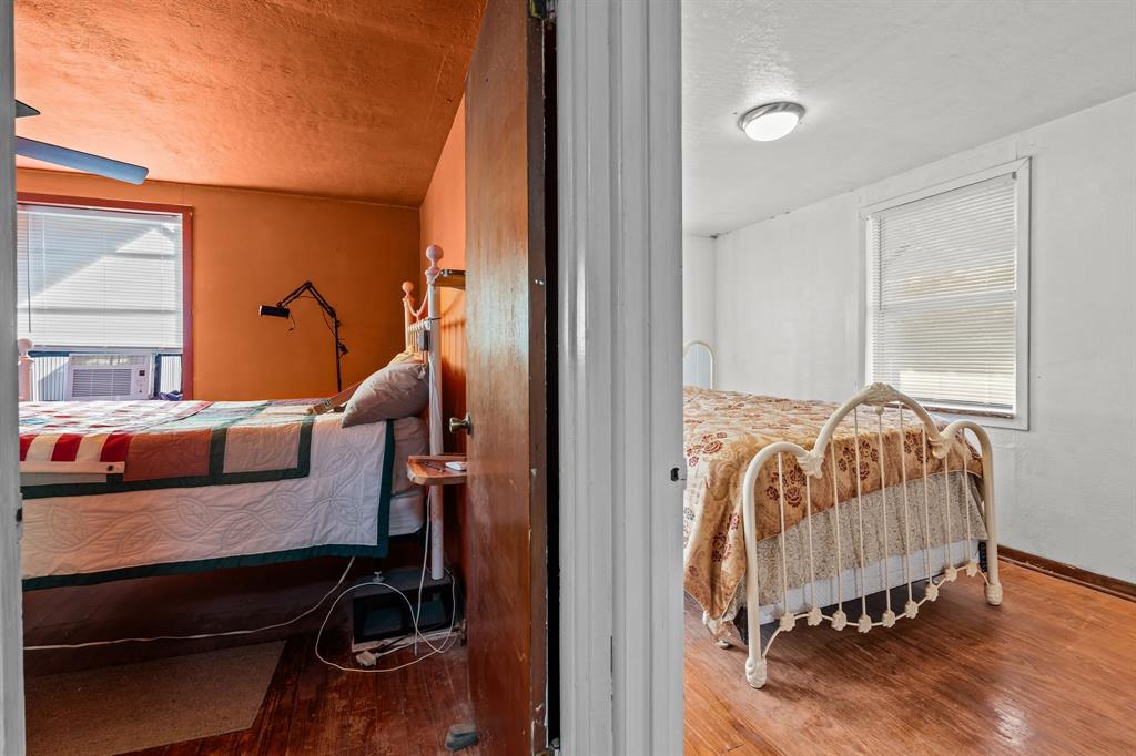 205 College Street Chico, TX 76431 - Photo 21 of 40 Bedroom with wood finished floors, a textured ceiling, and cooling unit