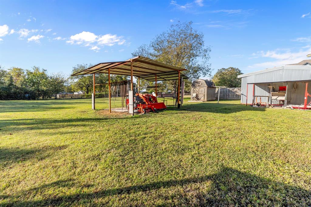 205 College Street Chico, TX 76431 - Photo 24 of 40 View of yard with an outbuilding and a patio