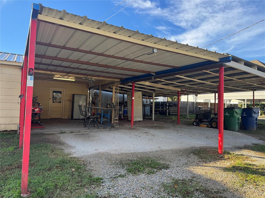 205 College Street Chico, TX 76431 - Photo 30 of 40 View of parking / parking lot with a carport