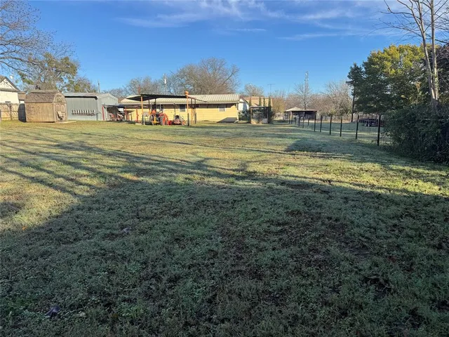 a view of a yard with a large trees