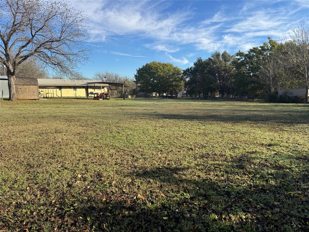 205 College Street Chico, TX 76431 - Photo 38 of 40 View of green lawn with an outbuilding