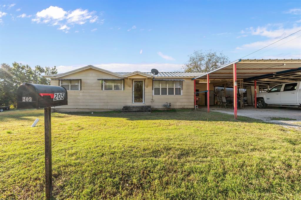 205 College Street Chico, TX 76431 - Photo 8 of 40 a view of a house with a swimming pool