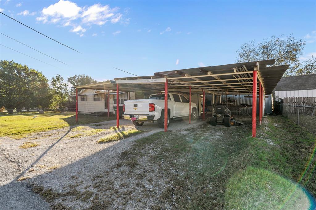 205 College Street Chico, TX 76431 - Photo 10 of 40 a view of a house with a backyard
