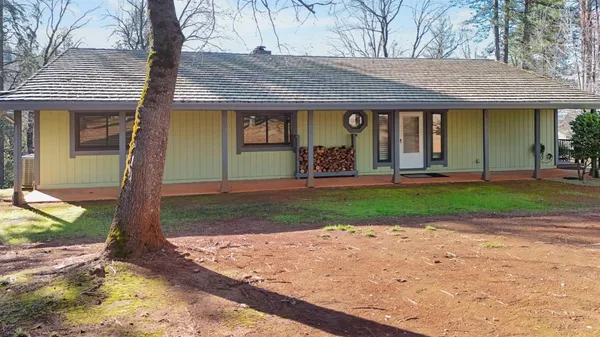 a front view of a house with garden and porch