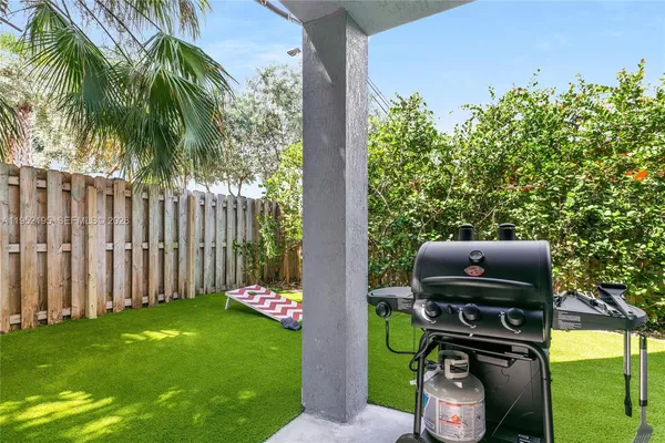 a view of two chairs next to a yard