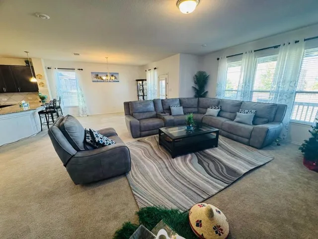 a living room with furniture and a large window