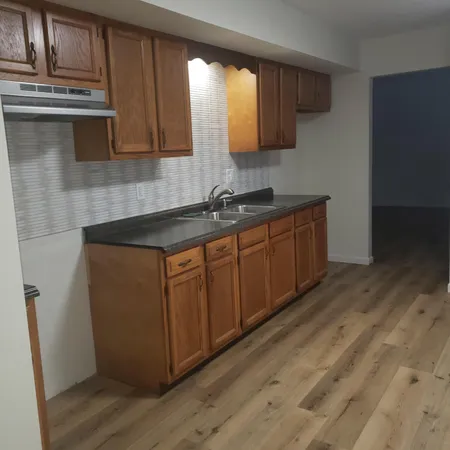 a kitchen with stainless steel appliances granite countertop a sink stove and microwave