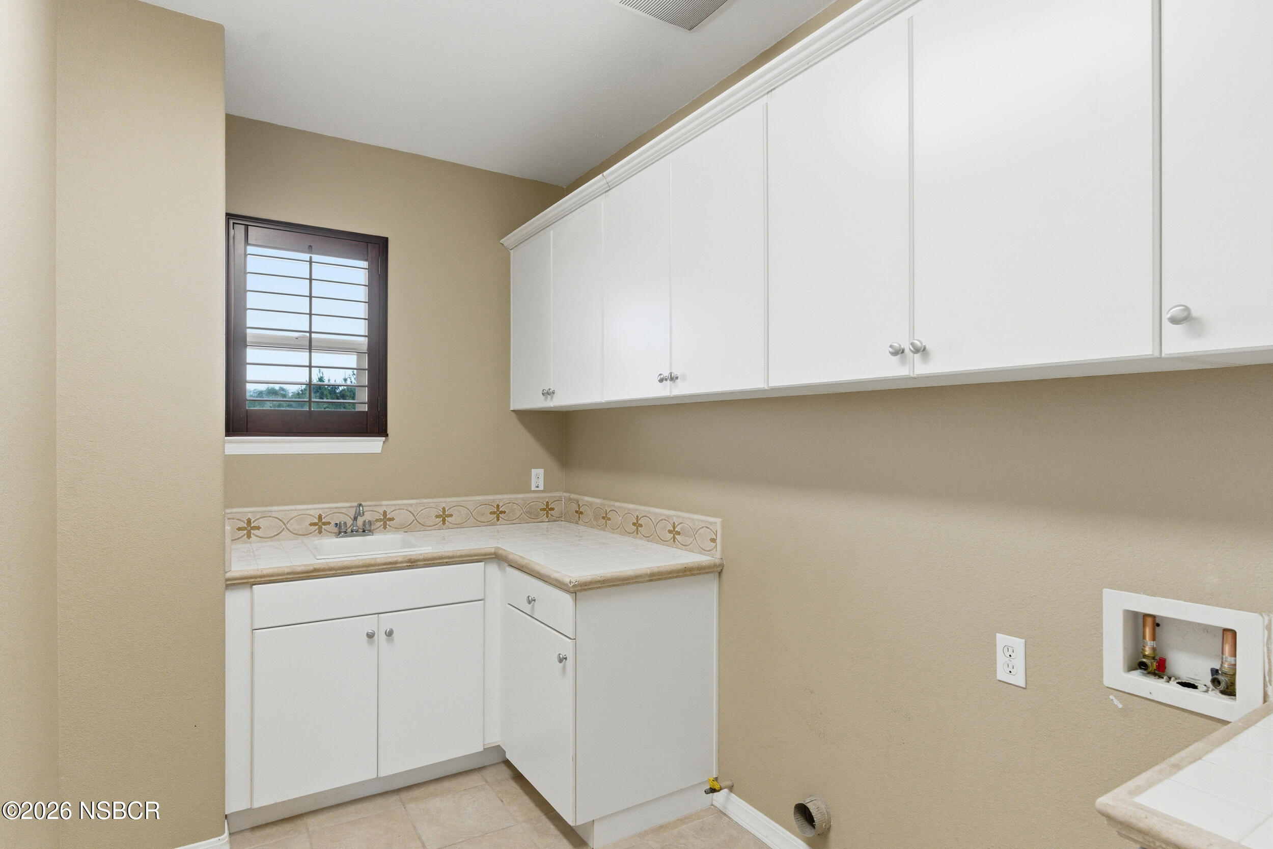 5632 Menemsha Lane Santa Maria, CA 93455 - Photo 43 of 66 a view of a kitchen with white cabinets