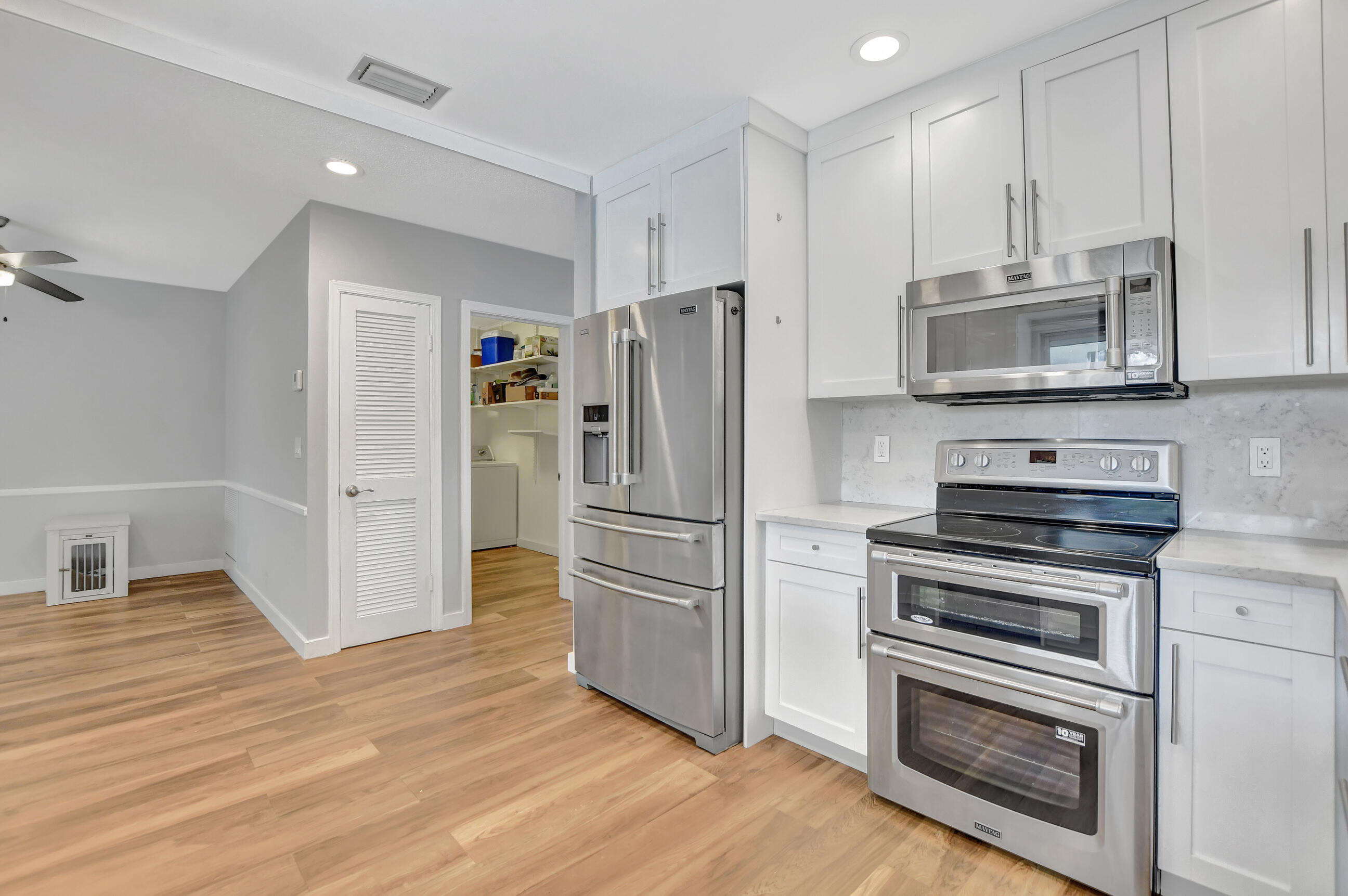 510 Silver Lane Boca Raton, FL 33432 - Photo 5 of 24 a kitchen with granite countertop a refrigerator stove and microwave