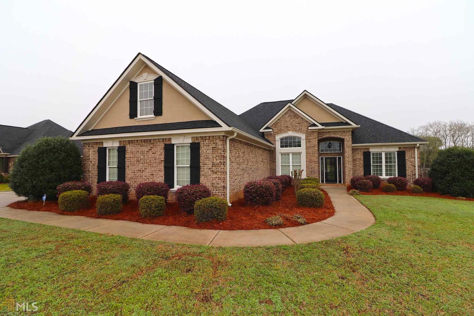a front view of house with yard and green space