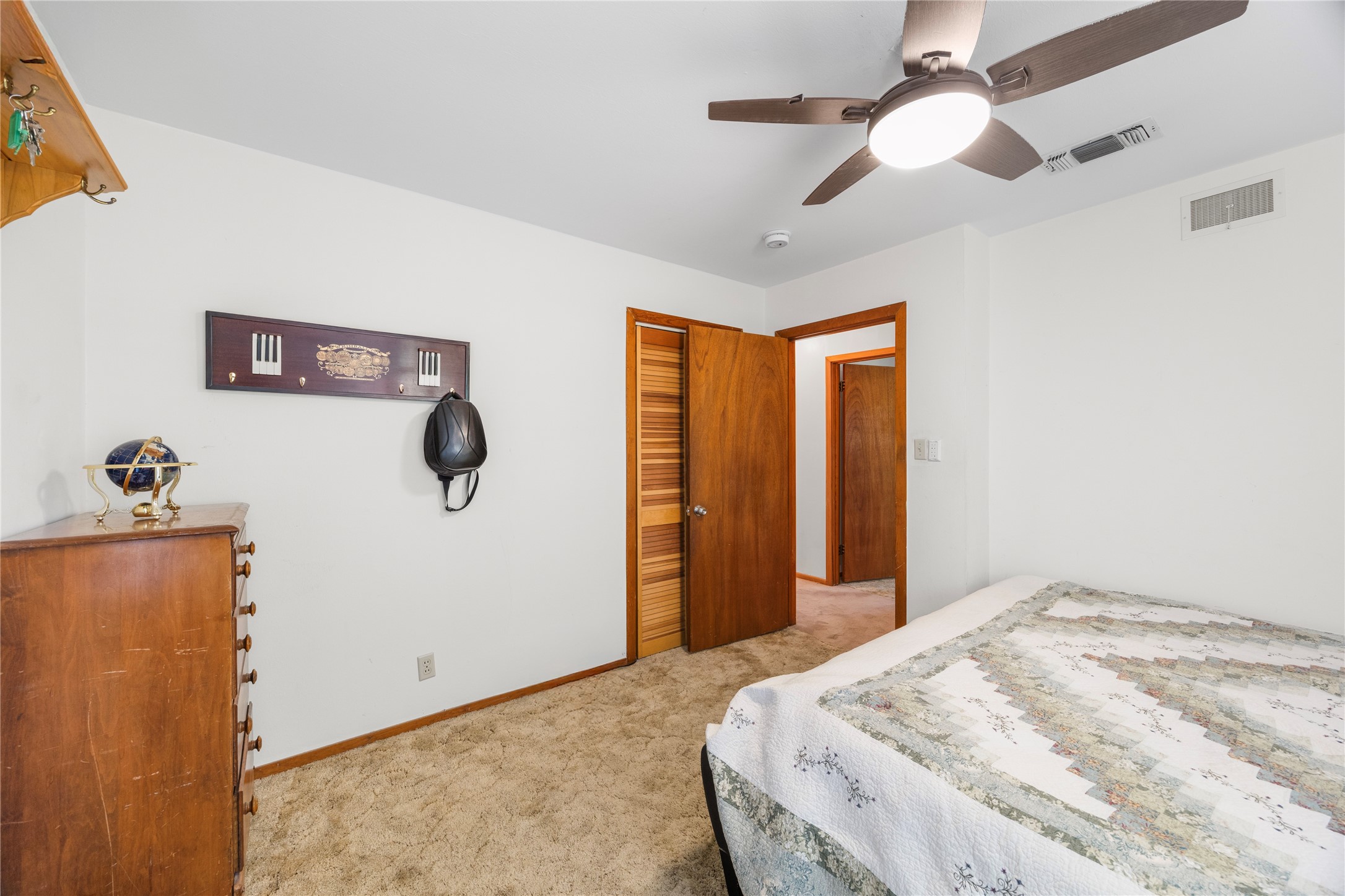 1324 Fair Drive Angleton, TX 77515 - Photo 16 of 42 a bedroom with a bed and a chandelier