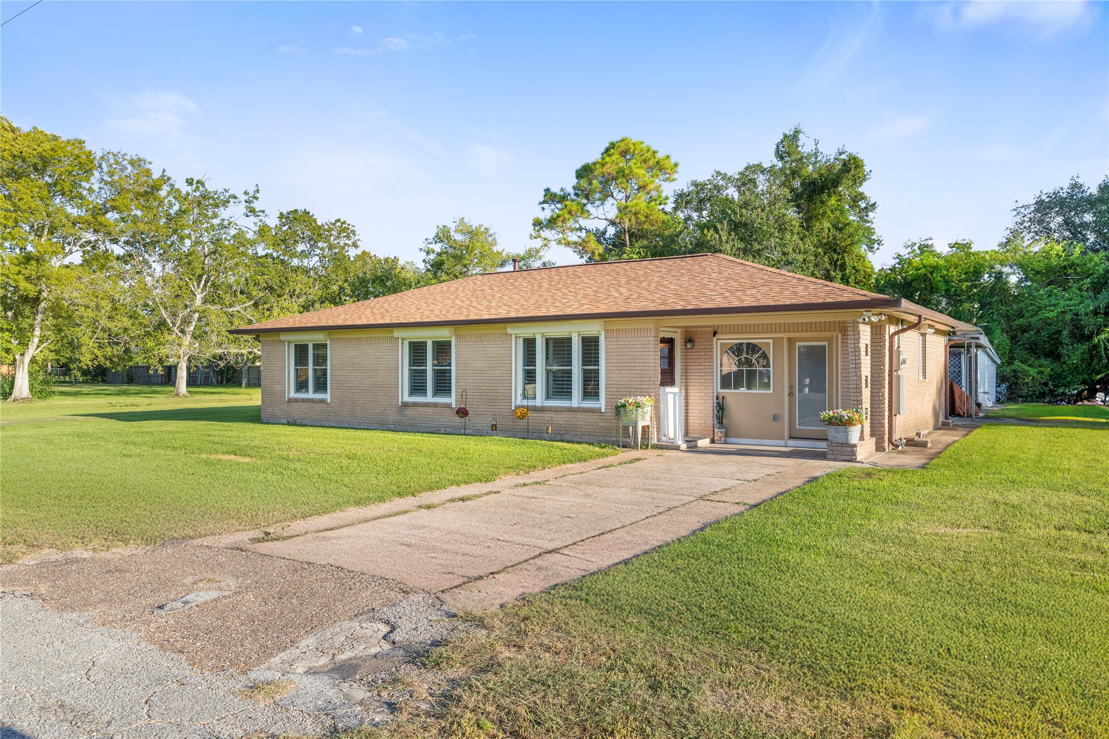 1324 Fair Drive Angleton, TX 77515 - Photo 4 of 42 a front view of a house with a yard and garage