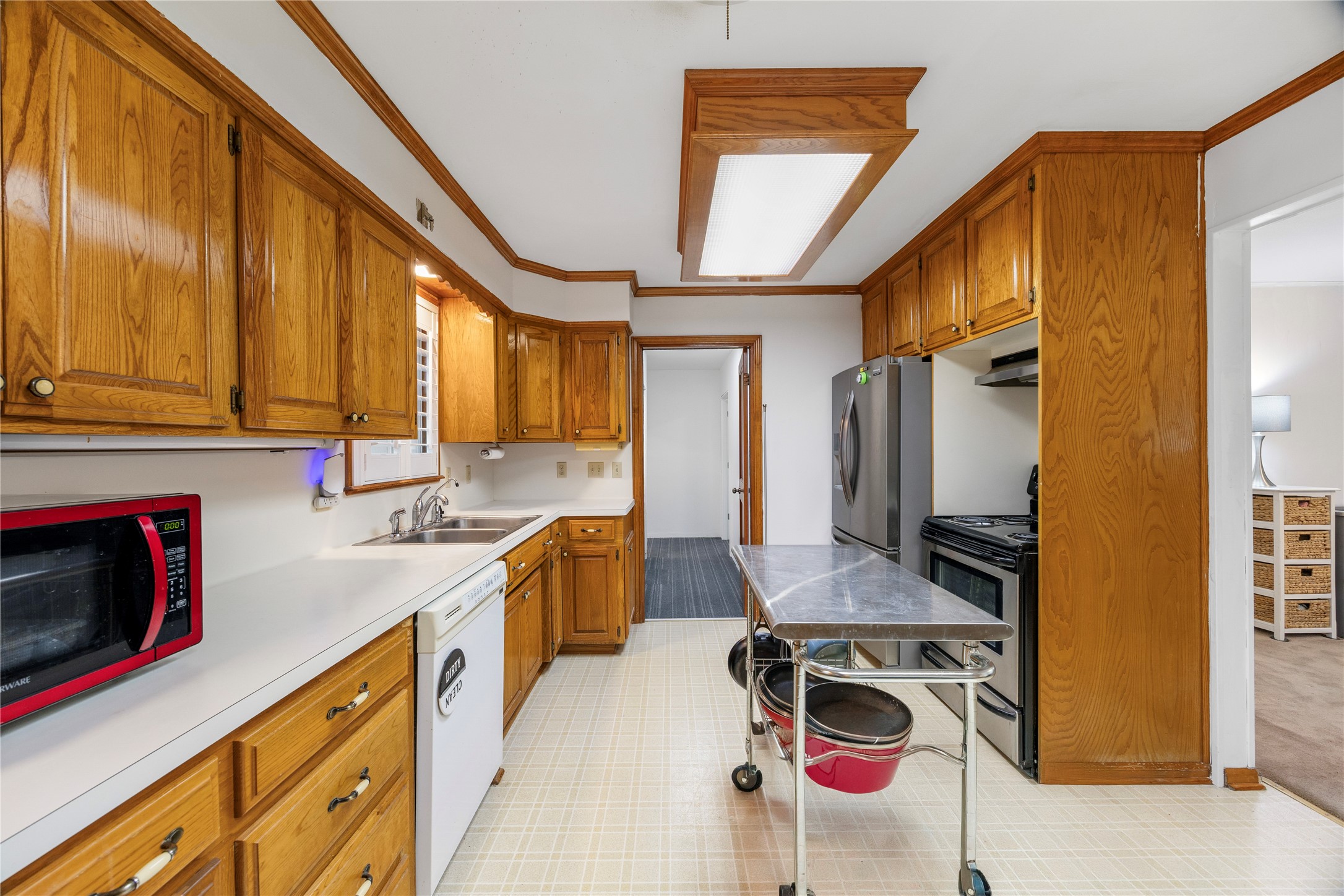 1324 Fair Drive Angleton, TX 77515 - Photo 10 of 42 a kitchen with stainless steel appliances granite countertop a stove a sink and a refrigerator