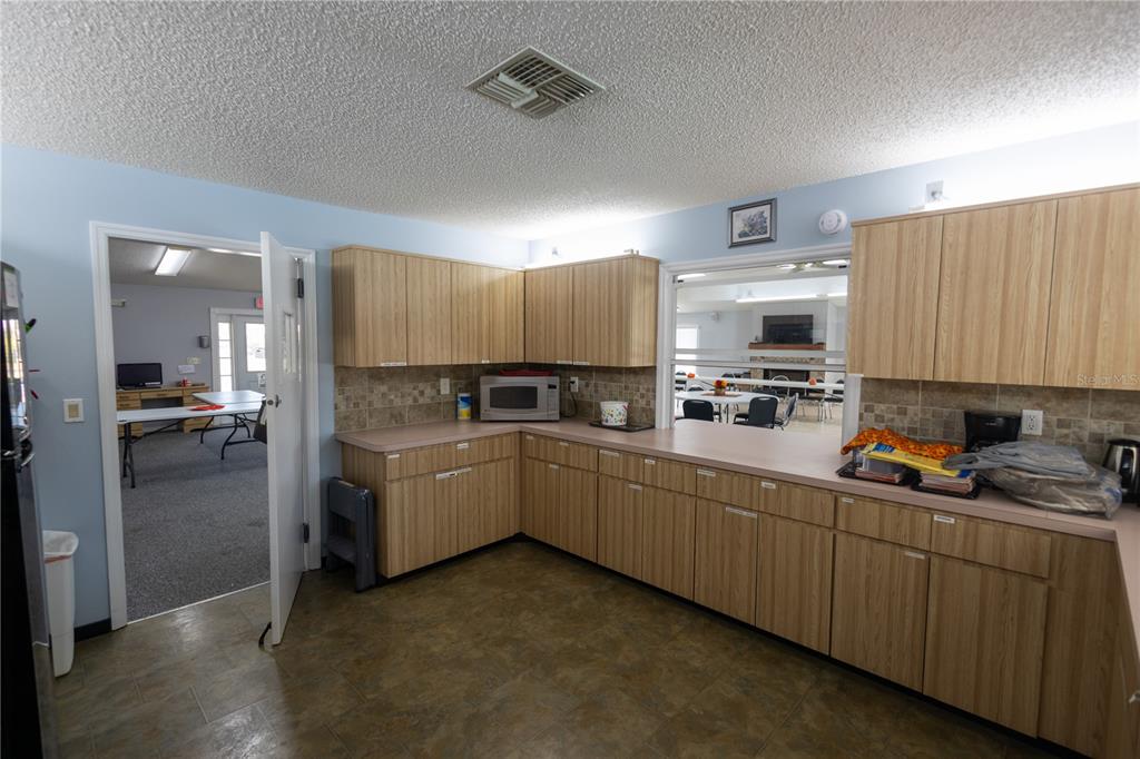 Forest Glenn Dr Spring Hill Spring Hill, FL 34607 - Photo 17 of 31 a kitchen with cabinets a sink and white appliances