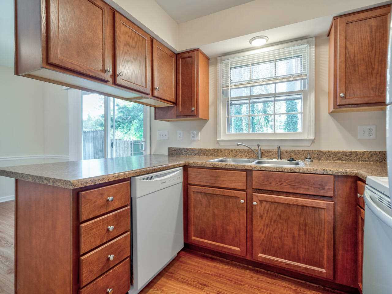 2220 New Hope Church Road Raleigh, NC 27604 - Photo 12 of 30 a kitchen with granite countertop wooden cabinets and a sink