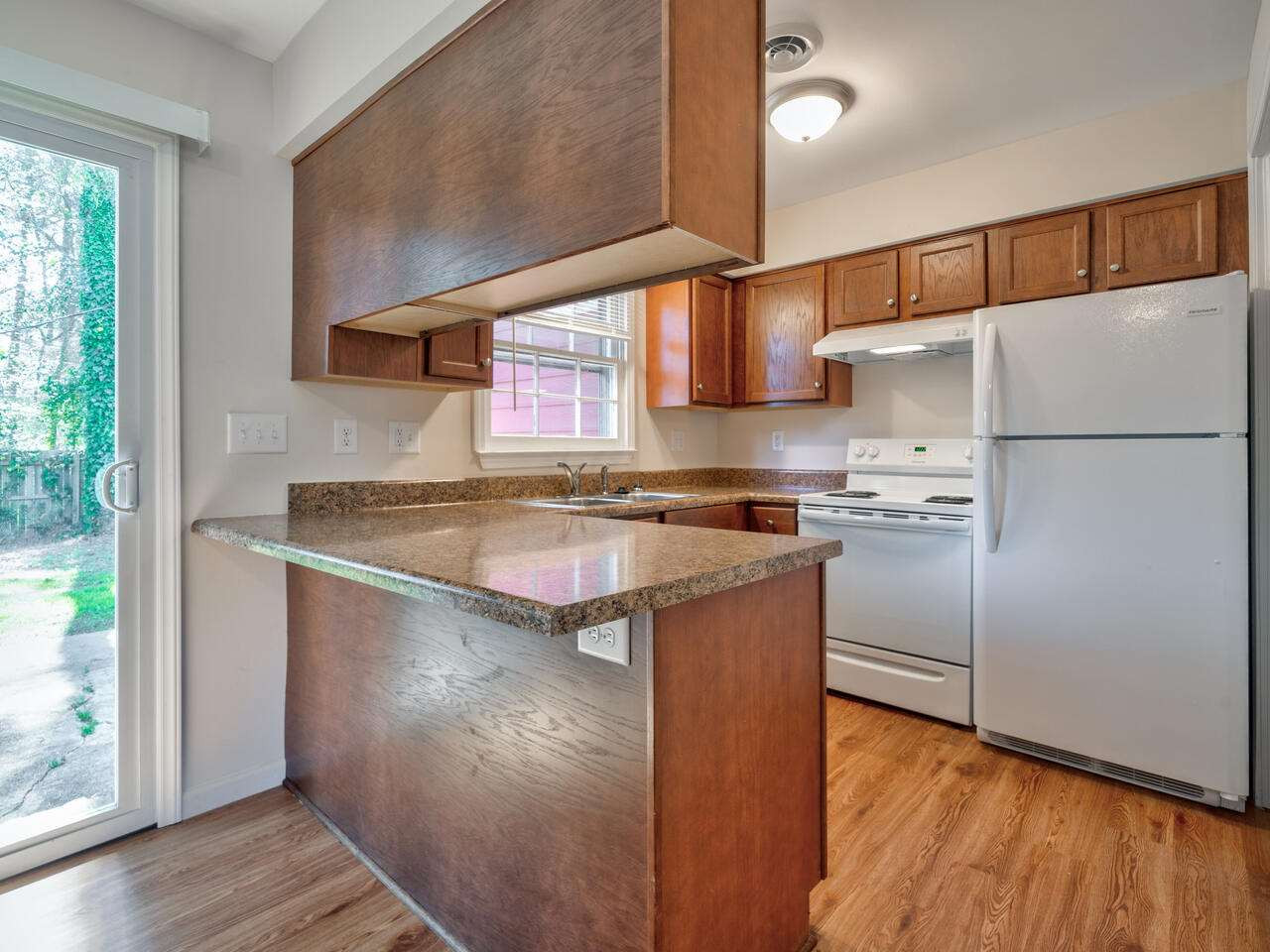 2220 New Hope Church Road Raleigh, NC 27604 - Photo 14 of 30 a kitchen with stainless steel appliances granite countertop a refrigerator a sink and a stove