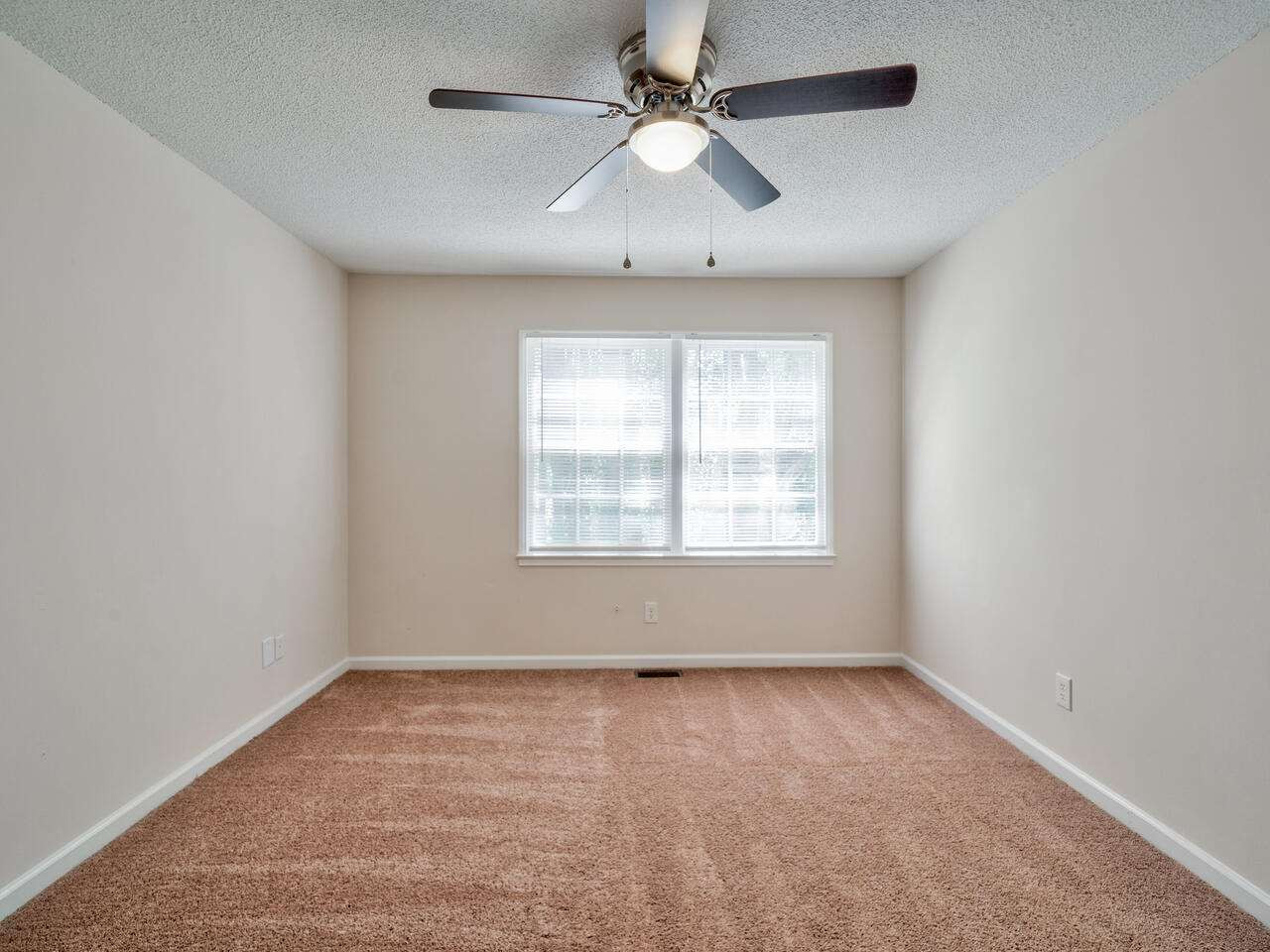 2220 New Hope Church Road Raleigh, NC 27604 - Photo 20 of 30 an empty room with a window and a fan