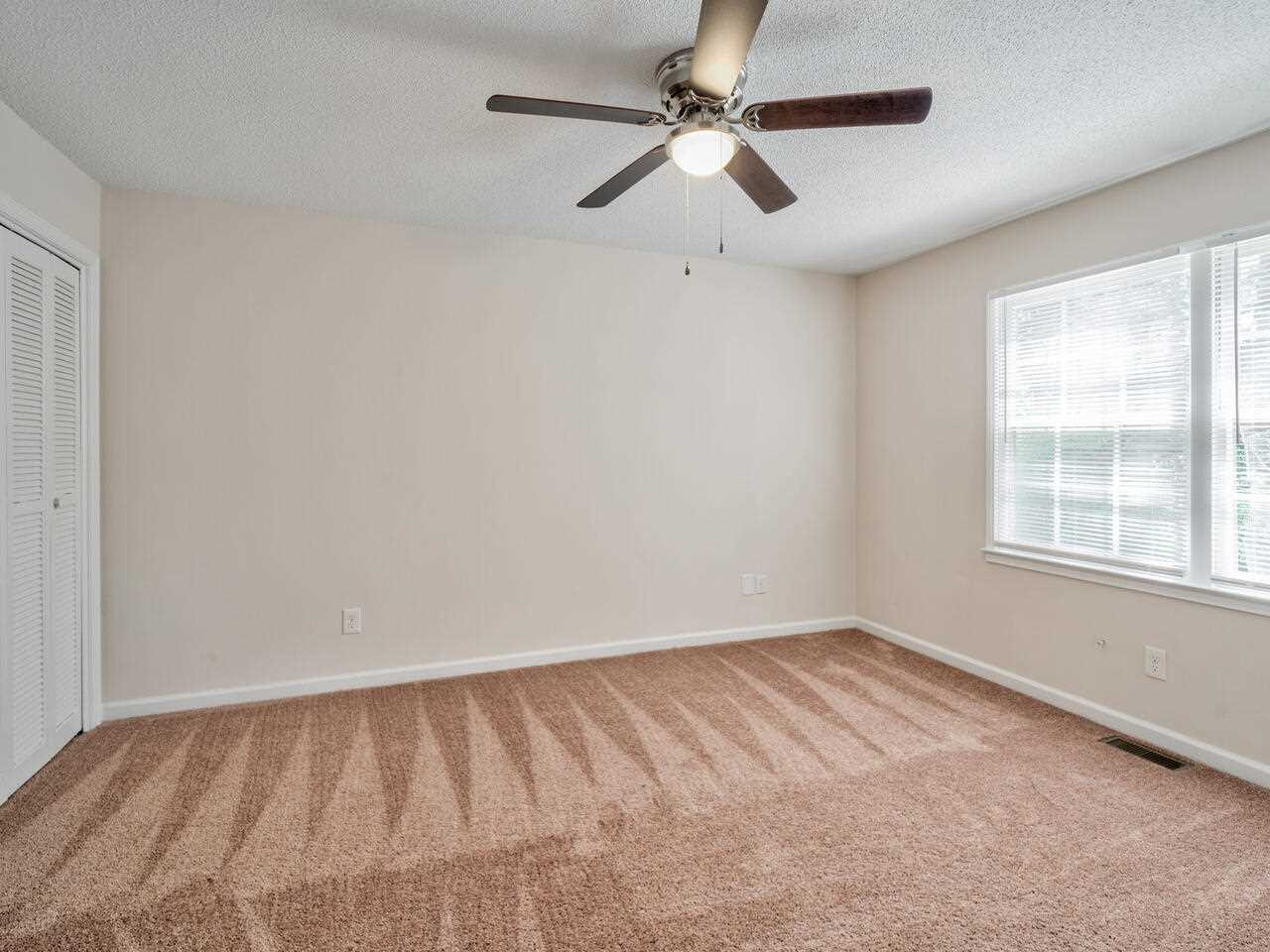 2220 New Hope Church Road Raleigh, NC 27604 - Photo 21 of 30 an empty room with a window and a fan