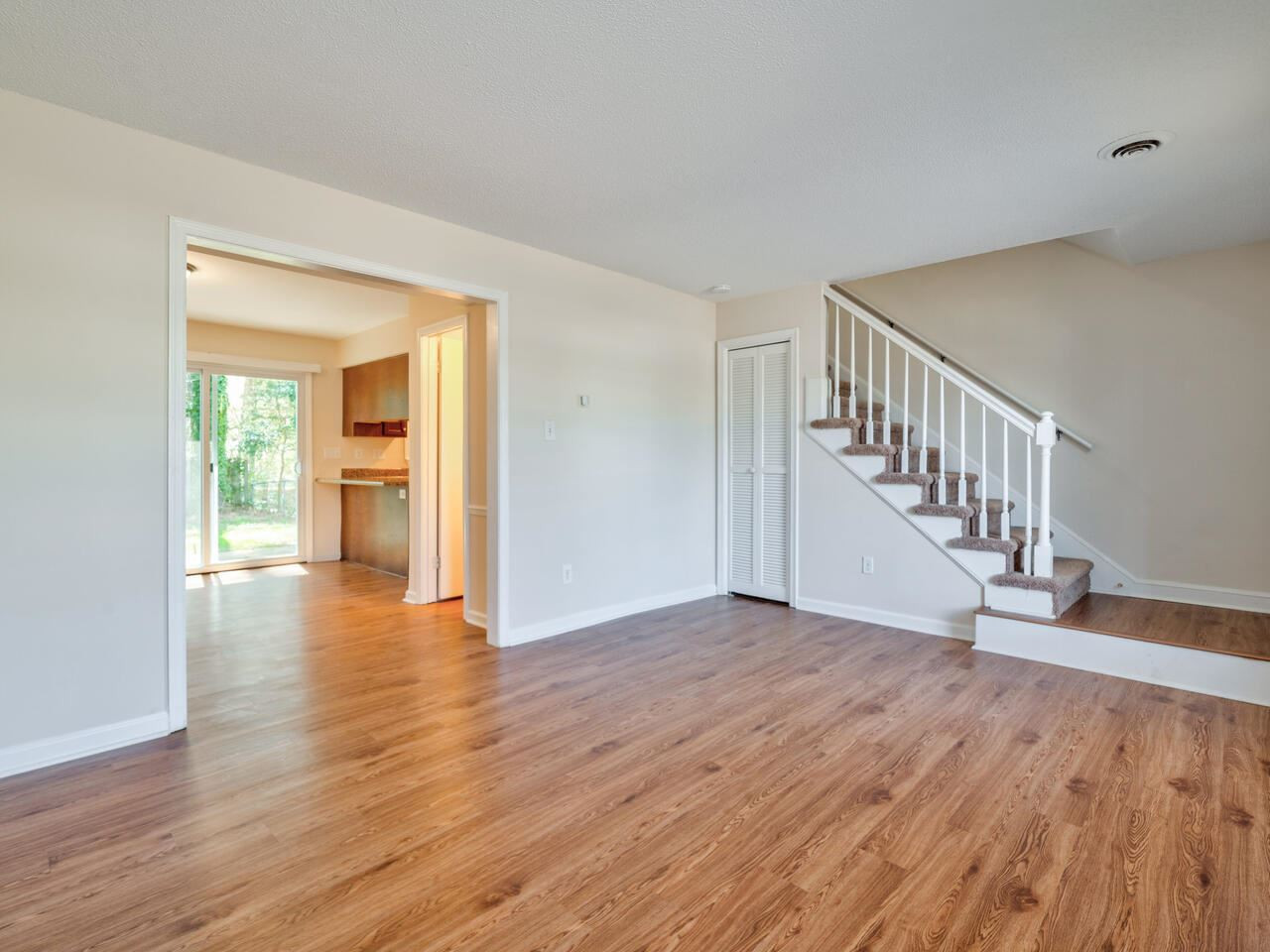 2220 New Hope Church Road Raleigh, NC 27604 - Photo 5 of 30 a view of an empty room with wooden floor and a window