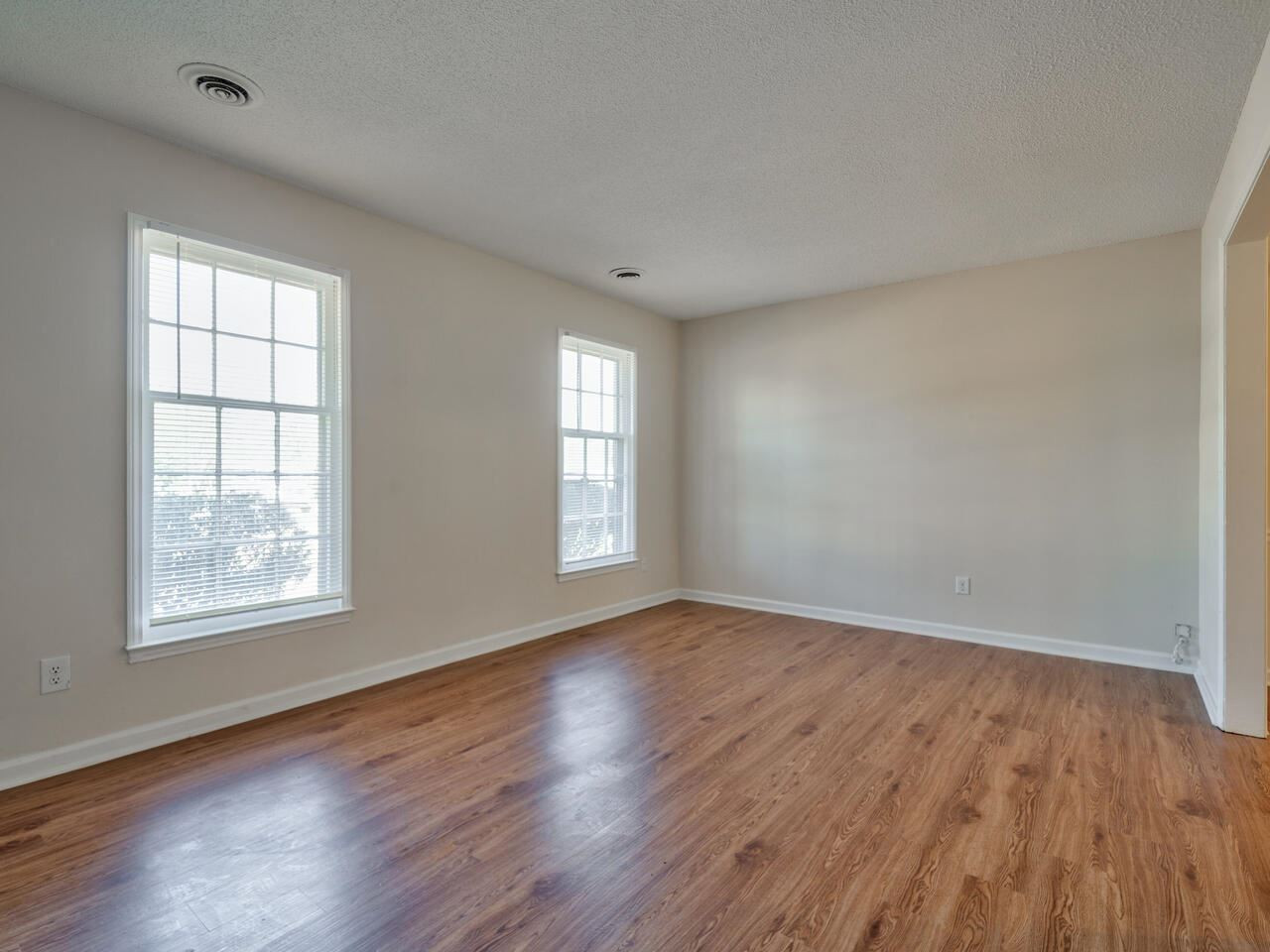 2220 New Hope Church Road Raleigh, NC 27604 - Photo 7 of 30 an empty room with wooden floor and windows