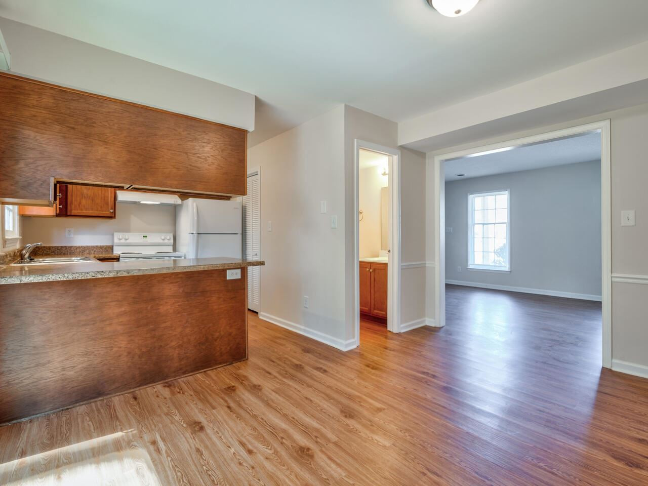 2220 New Hope Church Road Raleigh, NC 27604 - Photo 9 of 30 a view of a kitchen with wooden floor and a window
