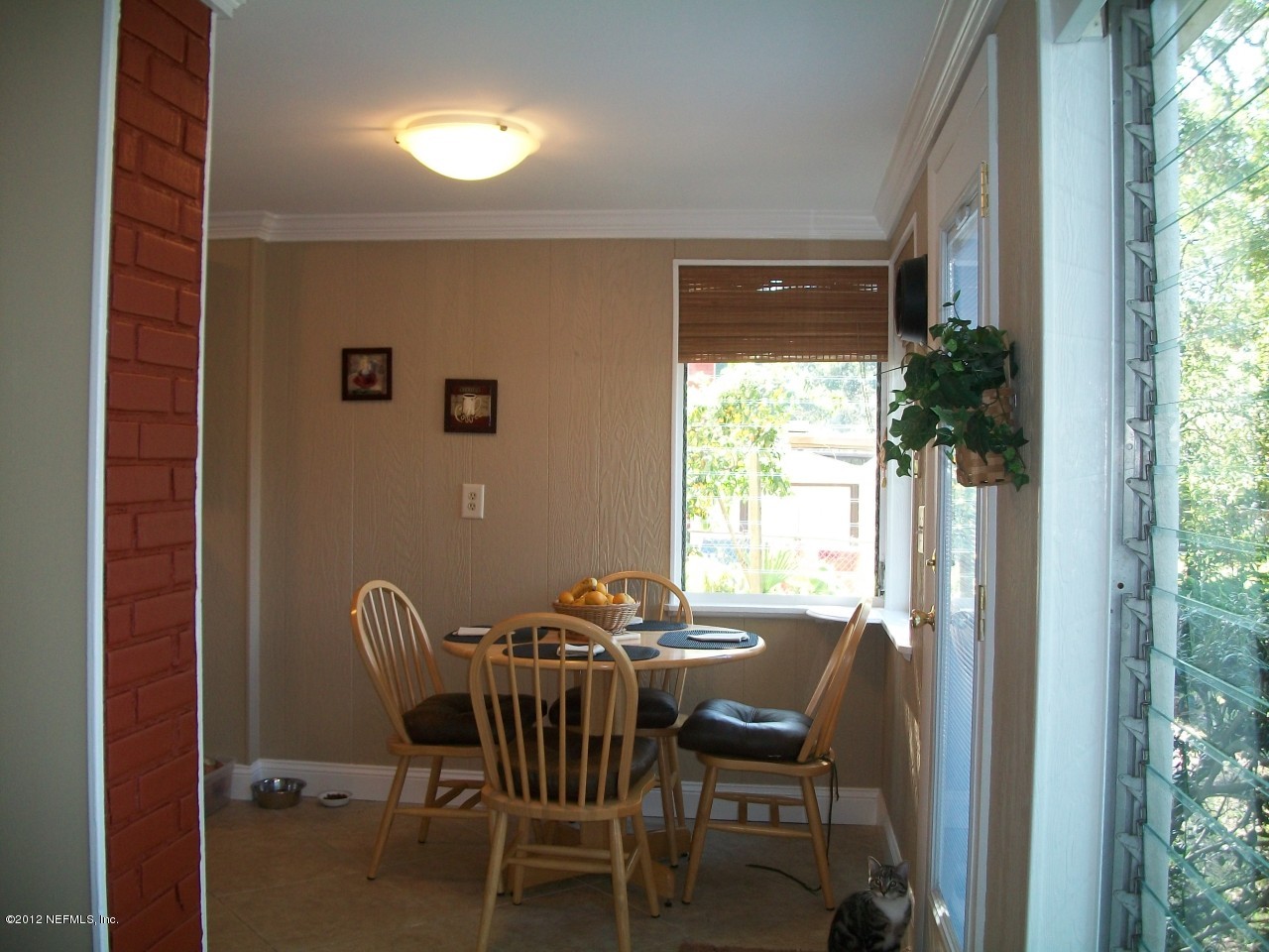 6038 Stetson Road Jacksonville, FL 32217 - Photo 37 of 55 a view of a dining room with furniture and a window