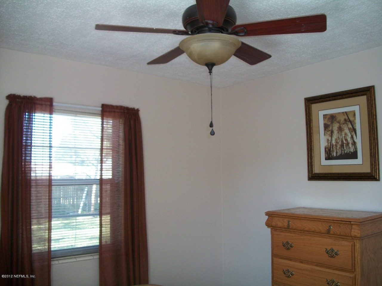 6038 Stetson Road Jacksonville, FL 32217 - Photo 46 of 55 a view of a livingroom with a chandelier fan and a window