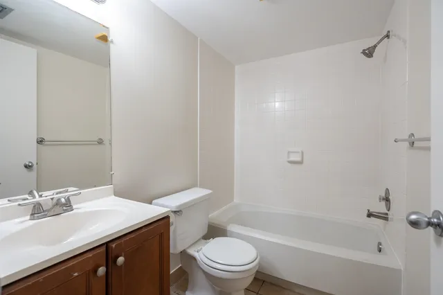 an empty room with a window and ceiling fan