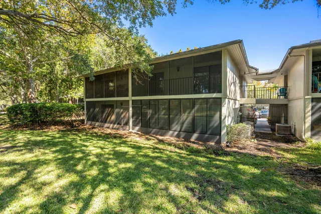 a view of a backyard with large tree