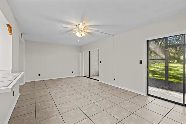 a view of empty room with window and cabinet