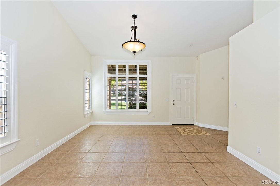 8476 Yarrow Lane Riverside, CA 92508 - Photo 3 of 27 an empty room with windows and fan