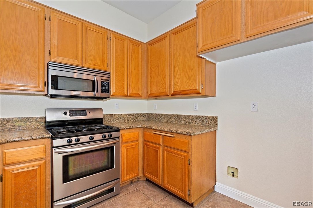 8476 Yarrow Lane Riverside, CA 92508 - Photo 6 of 27 a kitchen with granite countertop cabinets stainless steel appliances and a counter space